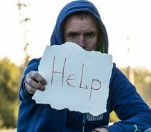 man with help sign
