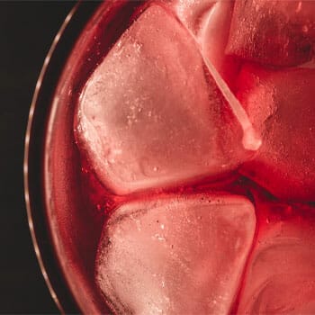 Cranberry juice with ice cubes in a glass
