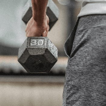 A person holding a 30lbs dumb bell