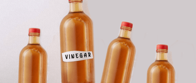 Four apple cider vinegar bottles