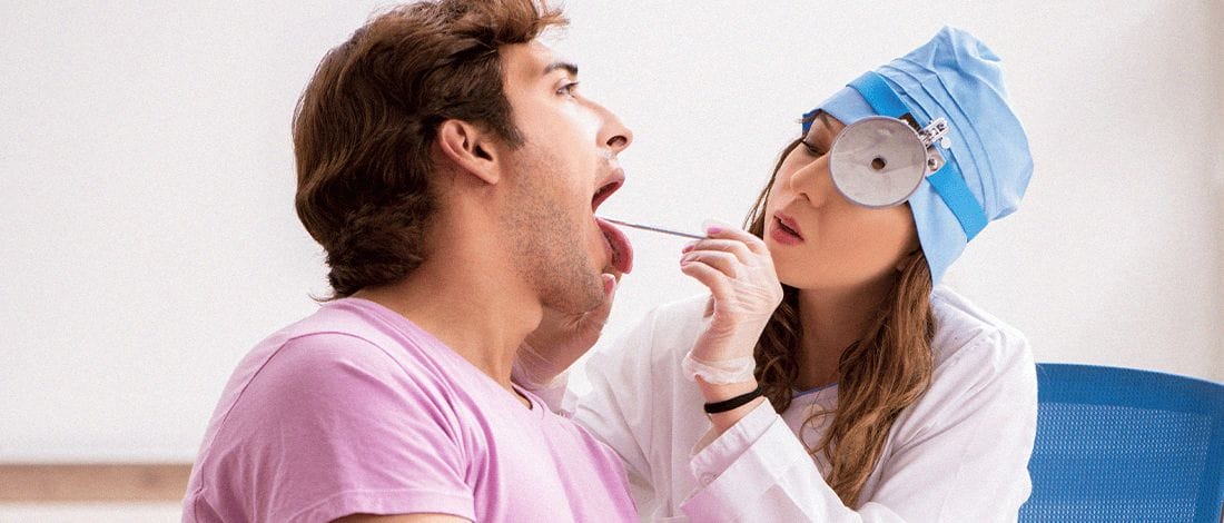 A patient doing a mouth swab drug test with a doctor inside the clinic