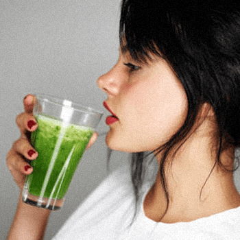 Woman drinking a detox drink to clean her system