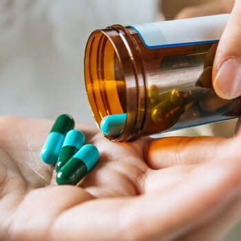 Pouring pills on hand