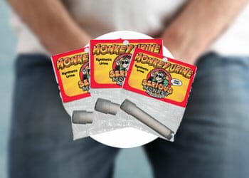 Three pieces of Monkey Urine kit with a man holding his crouch as background
