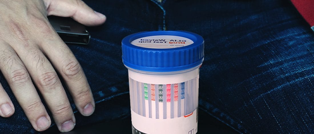 Identify® Drug Test Cups Review<br> Here’s Everything You Need to Know Drug test cup in between guy's pants