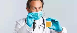 Shocked doctor looking at a urine sample