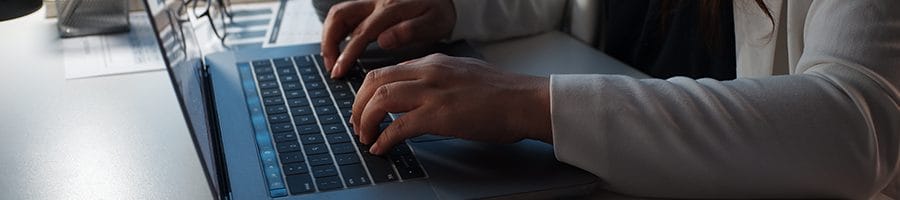 hand view of a person using her laptop
