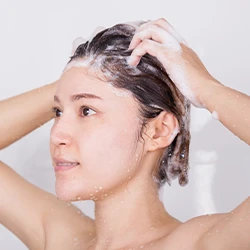 Woman using shampoo in her shower