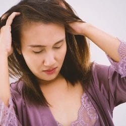 Woman scratching scalp