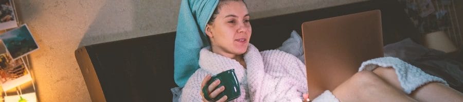 A woman in towels on her laptop
