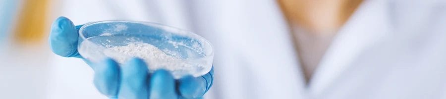 A doctor holding out powder on a dish