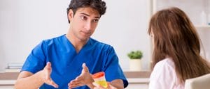 A patient having a discussion with the doctor about drug test