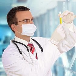 A doctor holding a test tube filled with urine