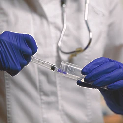 A doctor holding a drug test kit syringe