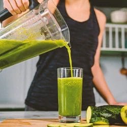 A woman pouring a detox drink