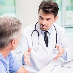 A doctor explaining to a patient the key differences of detox and rehab