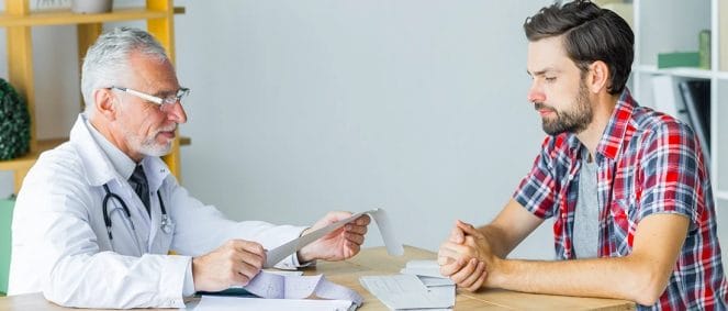 A man and a doctor discussing the pre-employment drug screening