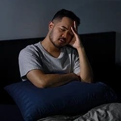A person experiencing insomnia as Ketamine withdrawal symptom