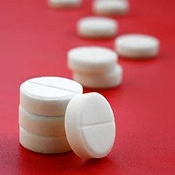 OxyContin tablets on a red background