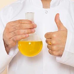 A person holding a synthetic urine and showing a thumbs up